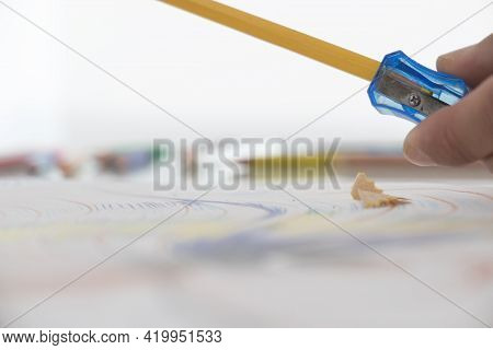 Pencil Sharpenerand Shavings On A White Background