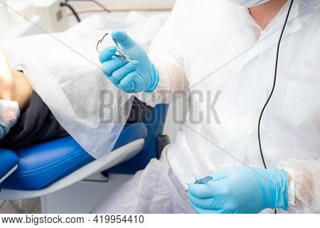 Dentist Doctor Holding Surgical Forceps, Suture Needle, Stapling Material