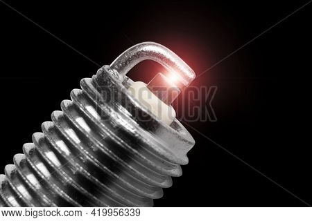 Macro Shot Of Sparks On Spark Plug Isolated On Black Background. A Spark Plug For An Engine Isolated