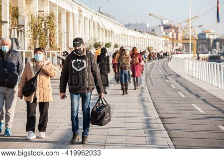 Belgrade, Serbia - February 13, 2021: Cargo Butler Delivery Man Wearing A Face Mask Protective Respi