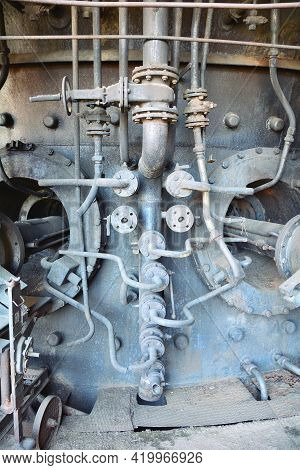 Old Abandoned Factory Interior With Many Rusty Piping. Rusty Piping In The Factory.