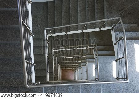 Piral Stairwell Going Down A Multiple Flights.