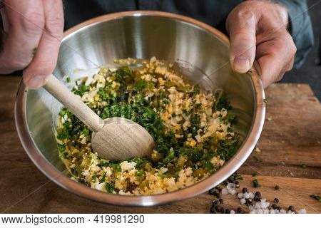 Preparing A Gribiche Sauce For Green Asparagus. Hands Stir Fresh Ingredients In A Bowl For A Tasty S