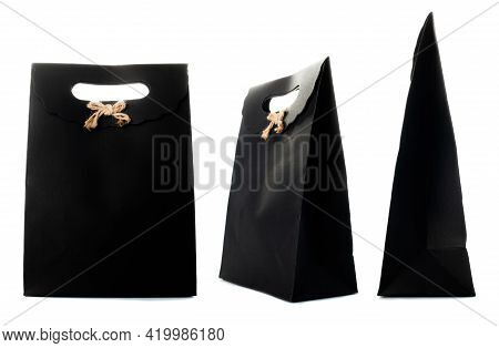 Black Paper Bag Isolated On White Background. Side, Front, Three-quarter View.