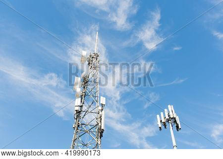 Radio, Communication And Cell Towers On Blue Sky Background