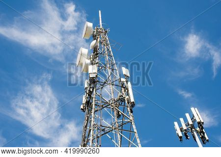 Radio, Communication And Cell Towers On Blue Sky Background
