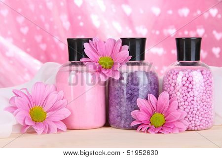Aromatherapy minerals - colorful bath salt on pink background