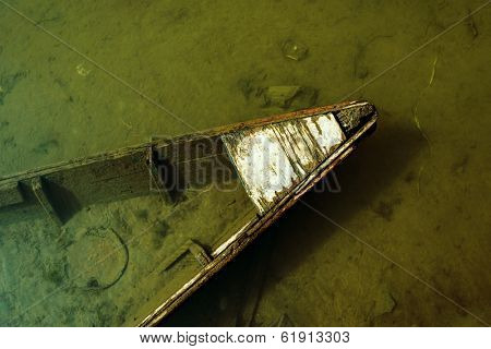 Sunken small wooden boat detail, cross processed effect