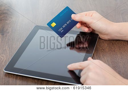 Female Hands Holding Credit Card And A Computer On The Table In The Office