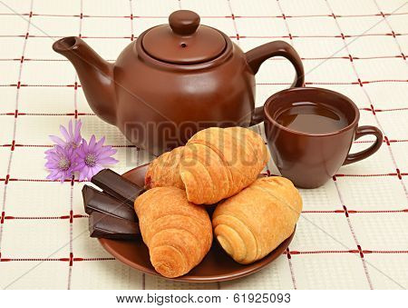Brown Teapot, Cup And Sauser With Croissant