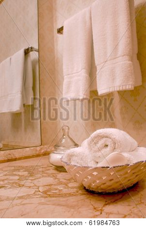 Towels in luxury bathroom with beige marble counter