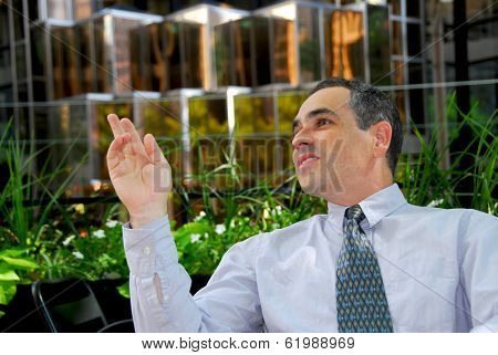 Businessman calling a waiter in outdoor cafe