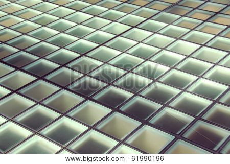 Background of glass squares floor lit from below