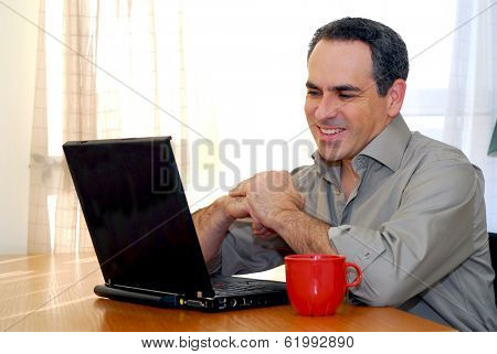 Man sitting at a desk and looking into his computer