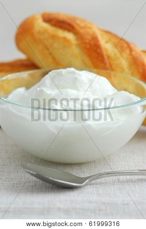 Fresh yogurt served in a clear glass bowl
