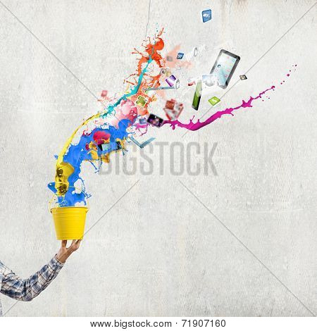 Close up of hand splashing colorful paint from bucket