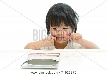 Little asian baby playing with mother's cosmetics