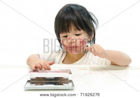 Little asian baby playing with mother's cosmetics