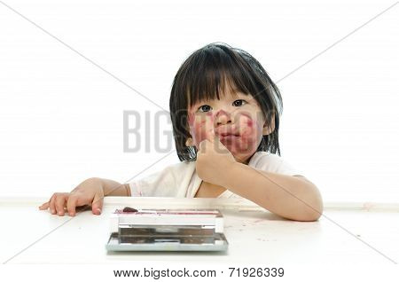 Little asian baby playing with mother's cosmetics
