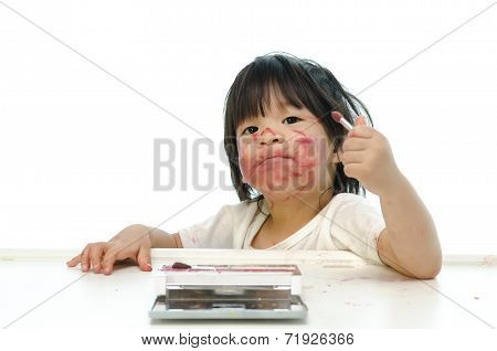 Little asian baby playing with mother's cosmetics