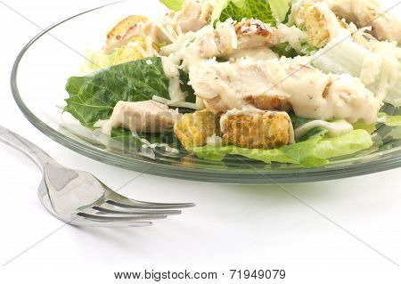 Chicken Caesar salad isolated on a white background with crutons and thick creamy dressing