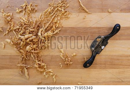 Chip Shavings with Spokeshave of Sapele Hardwood Board