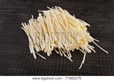 rennet cheese spaghetti on wooden table surface 