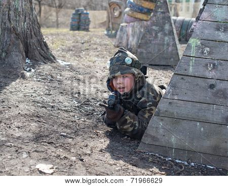 Little boy player with gun during lasertag game.