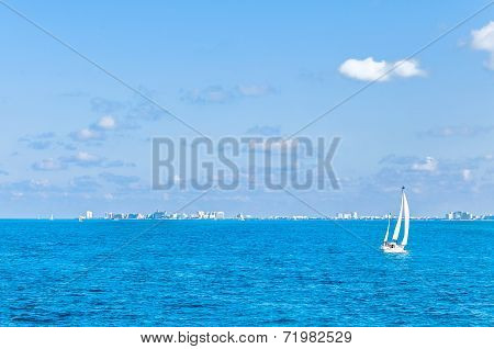 tropical sea, boat and Cancun skyline - Mexico