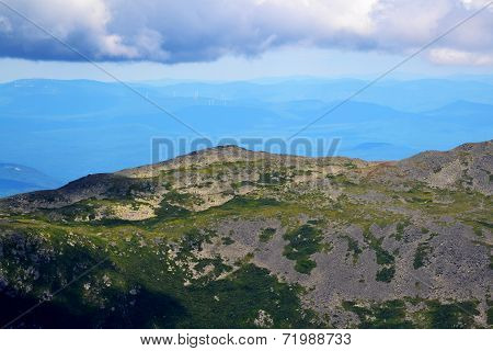 Clouds On Top Of A Huge Mountain Range