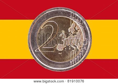 Common Face Of Two Euro Coin On Flag Of Spain