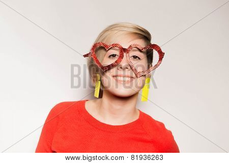 Valentine's Day. Girl with glasses in the shape of heart
