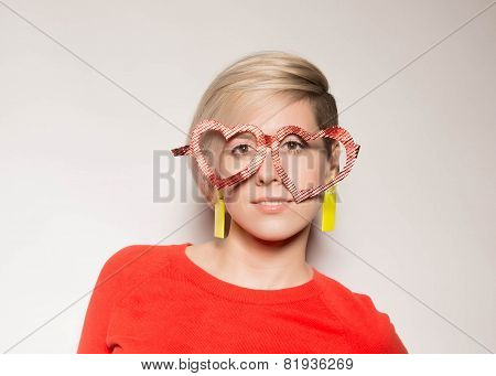 Valentine's Day. Girl with glasses in the shape of heart