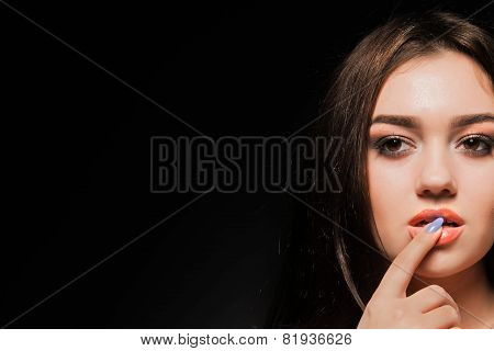Beautiful brunette with long hair on a dark background