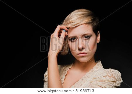 Blonde girl with a short stylish haircut on a dark background