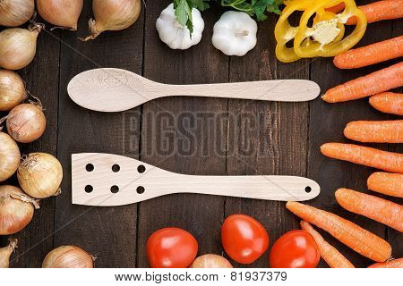 Wooden kitchenware with vegetables mix on the table