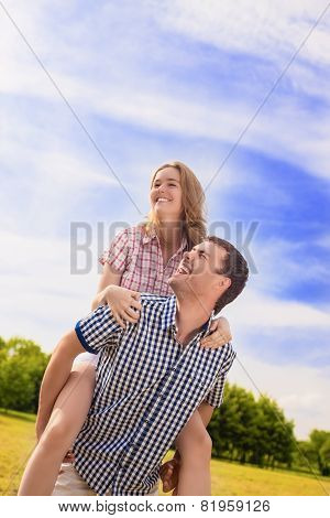 Portrait Of Happy Caucasian Couple Playing Outdoors In Summer. Having Fun While Piggybacking And Hap