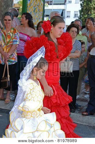 Spanish girls in flamenco dresses.