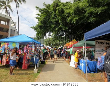 People Explore Booths That Line Pathway At Earth Day Celebration Festival