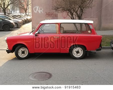 PRAGUE CZECH REPUBLIC - CIRCA MARCH 2015: Red Trabant car parked in a street of the city centre
