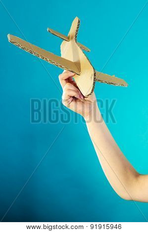 Woman Holding Airplane In Hand.