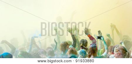 Crowd Dancing And Waiving Arms In The Sky In Happiness