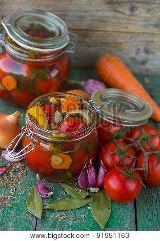 Open glass jar of tasty canned tomatoes