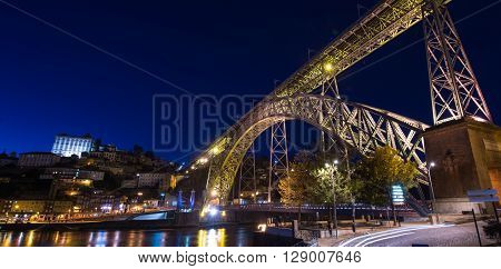 City of Porto by night in Portugal, the Old Town and Ponte Dom Luiz I arch bridge over Douro river.