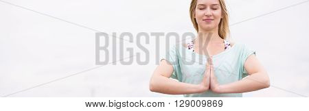 Beautiful young woman doing yoga meditation outdoor