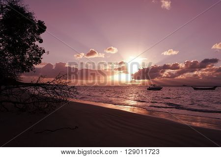 Sunset On The Beach With The Boats On The Sea