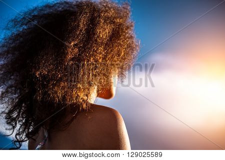Happy Girl In Her Red Curly Hair Looks In The Sun