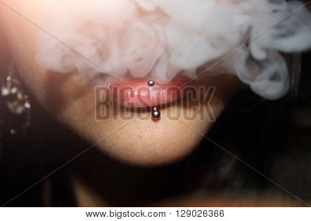 The Girl With The Pierced Lip Produces The Smoke Cigarettes