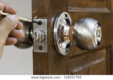 closeup of locksmith on old wood door repair
