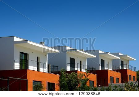Facades of a modern houses condominium in a sunny day